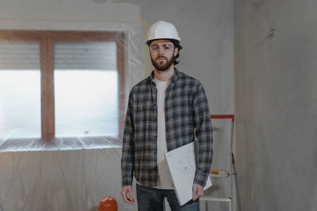 Electrician reviewing plans during a commercial renovation